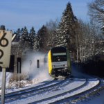 Zug auf Schienen bei Schneefall